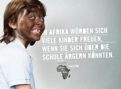 A UNICEF poster showing a young white child with a face painted brown.