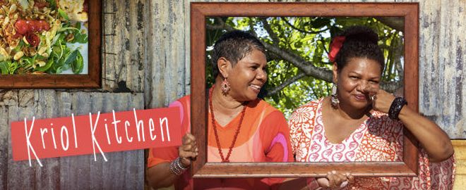 Two smiling Aboriginal women holding a picture frame.