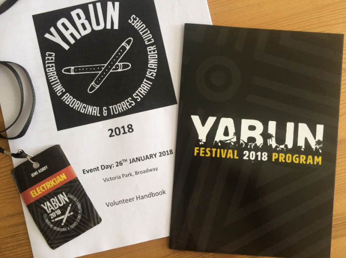Badge and program for volunteers at the Yabun 2018 Aboriginal event.