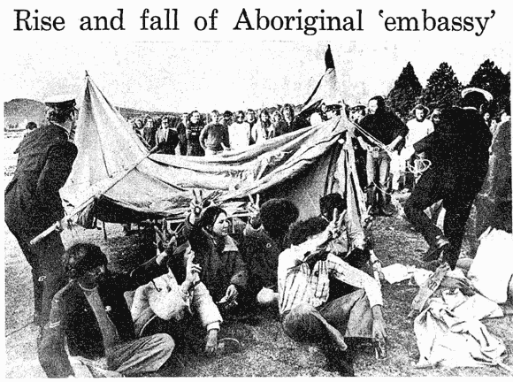 Police removes tents while Aboriginal people sit in protest.